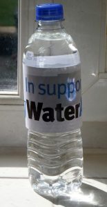 A bottle of water to be filled with coins in support of WaterAid