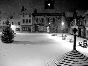 "Alnwick marketplace - snow - night" by Andy Armstrong - http://www.flickr.com/photos/andyarmstrong/89441086/sizes/o/. Licensed under Creative Commons Attribution-Share Alike 2.0 via Wikimedia Commons - http://commons.wikimedia.org/wiki/File:Alnwick_marketplace_-_snow_-_night.jpg#mediaviewer/File:Alnwick_marketplace_-_snow_-_night.jpg