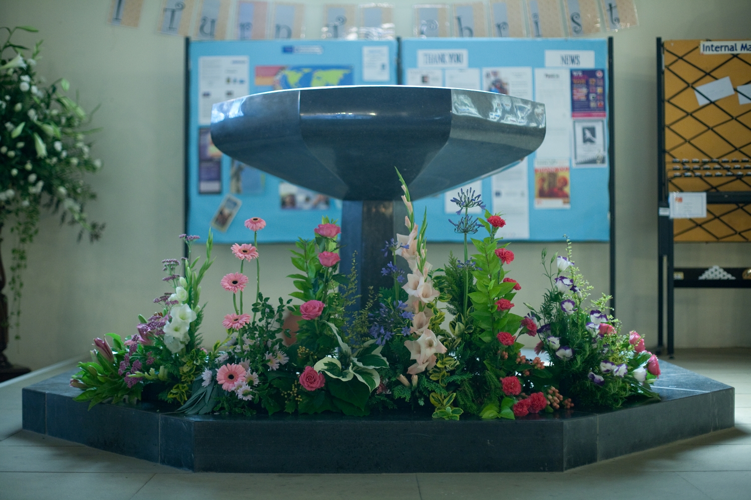 The font with flower arrangements at its base
