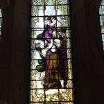 Stained glass depiction of "charity" at St Peter the Fisherman, Craster