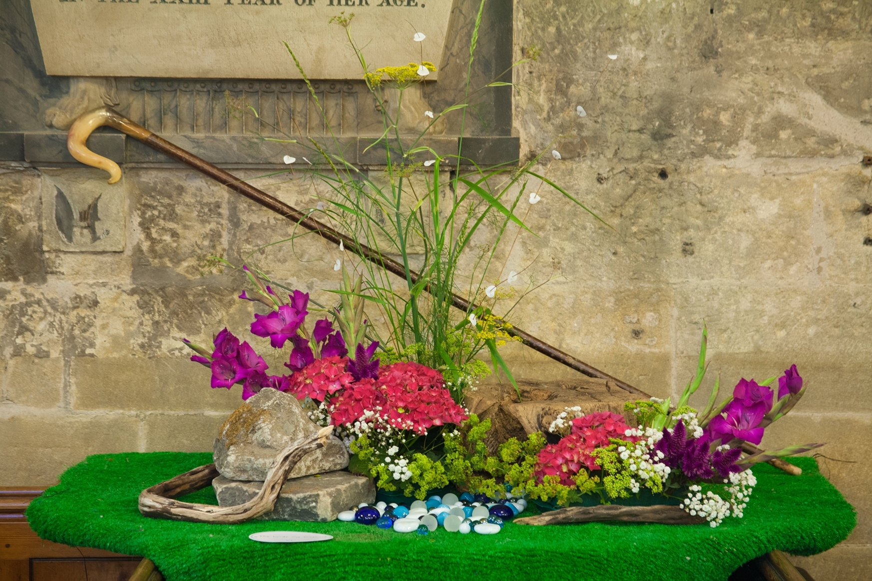 A flower arrangement inside St Michael's Church surmounted with a shepherd's crook